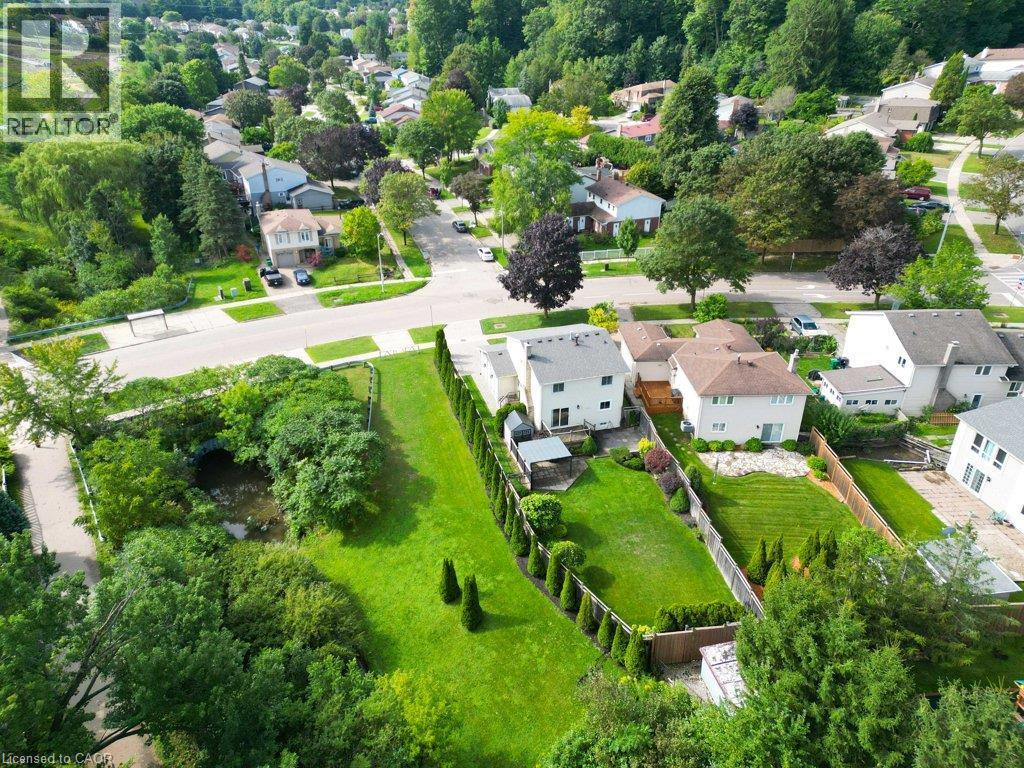Expansive green space with mature trees, established residential streetscape, and a water feature - 238 Mcgarry Drive, Kitchener, ON