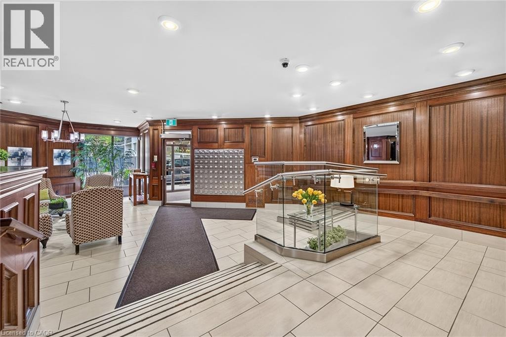 Building lobby featuring wood-paneled walls and light-toned tile flooring - 1237 North Shore Boulevard Unit# 405, Burlington, ON