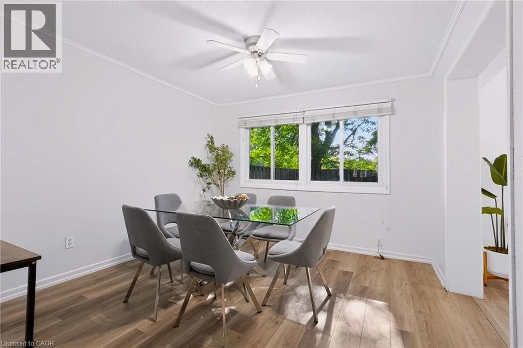 Wood-finish flooring, white walls, white window trim, and a ceiling fan - 121 University Avenue E Unit# 102, Waterloo, ON