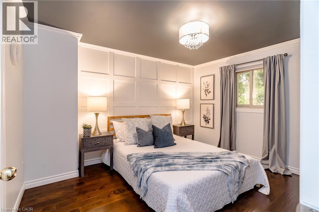 Rich wood-finish flooring complements the detailed wall paneling - 543 Drummerhill Crescent, Waterloo, ON