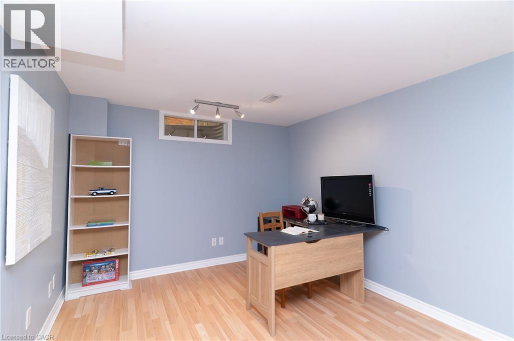 Recessed window with white trim, track lighting fixture, light wood-finish flooring, and white baseboards - 543 Drummerhill Crescent, Waterloo, ON