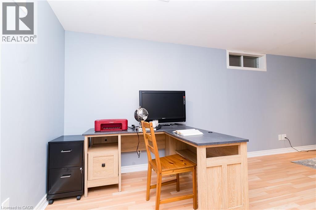 Light blue painted walls, wood-finish flooring, and a single transom window - 543 Drummerhill Crescent, Waterloo, ON