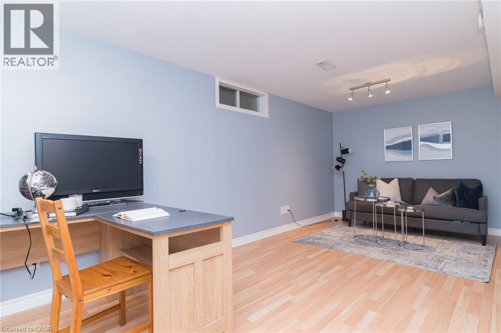 Light wood-finish flooring with crisp white trim - 543 Drummerhill Crescent, Waterloo, ON