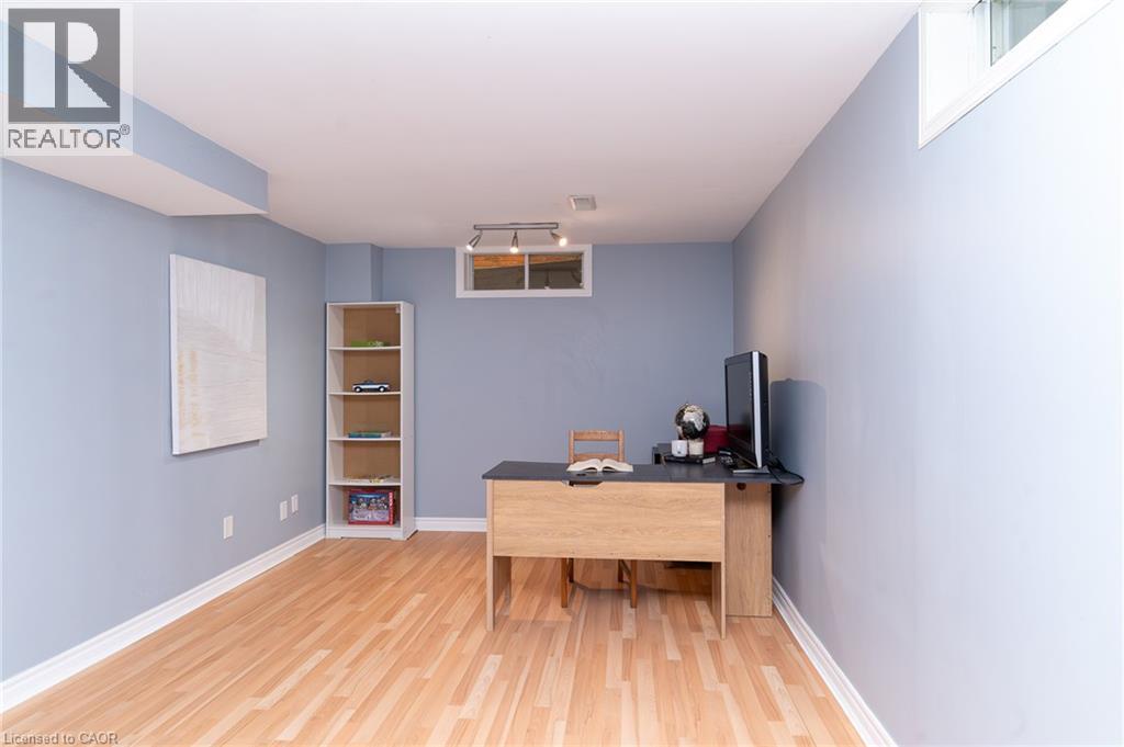 Wood-finish flooring with white trim, light blue walls, and a built-in window - 543 Drummerhill Crescent, Waterloo, ON