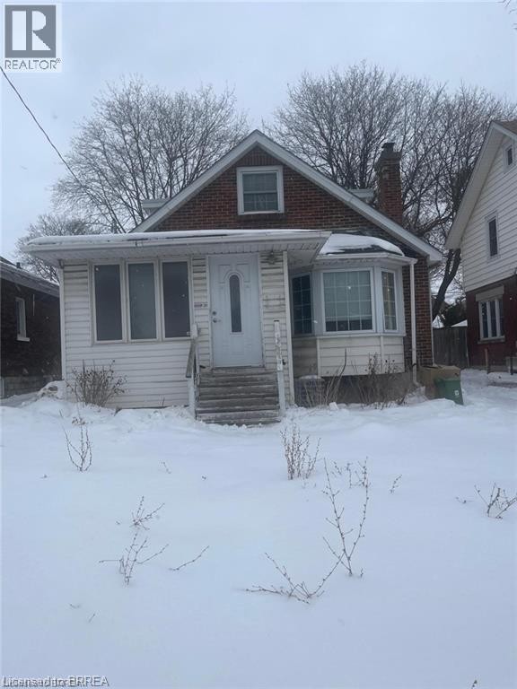 Brick and siding exterior with a prominent front bay window - 258 Wellington Road, London, ON