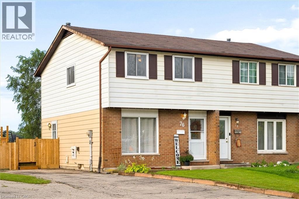 Two-story exterior featuring brick and horizontal siding, with a brown shingle roof and white framed windows - 76 Cluthe Crescent, Kitchener, ON