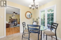 Tiled flooring, overhead chandelier, and glass patio doors -