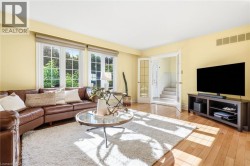Hardwood flooring, French doors, multiple windows, and a built-in media console -