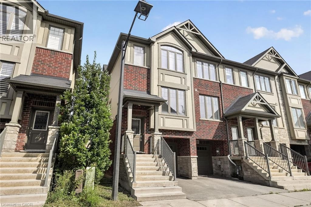 Brick and stucco facade with multi-pane windows - 1169 E Garner Road E Unit# 66, Ancaster, ON