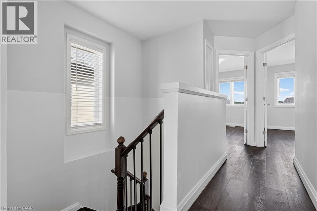 Hardwood-finish flooring, white trim, and white walls throughout - 1169 E Garner Road E Unit# 66, Ancaster, ON