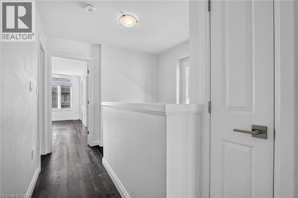 Wood-finish flooring throughout the hallway - 1169 E Garner Road E Unit# 66, Ancaster, ON