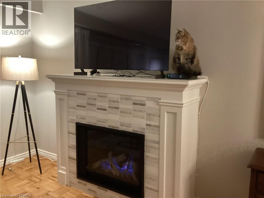Built-in fireplace with a tile surround and mantel - 3158 Palmer Drive, Burlington, ON