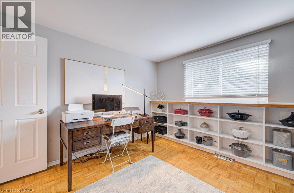 Parquet wood-finish flooring, built-in shelving with wood-finish tops, white paneled door, and a window with horizontal blinds - 3158 Palmer Drive, Burlington, ON