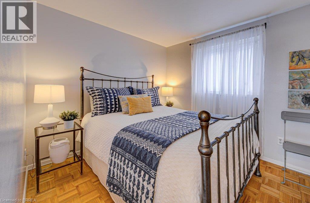 Parquet wood-finish flooring, neutral wall tones, and window with sheer drapery - 3158 Palmer Drive, Burlington, ON