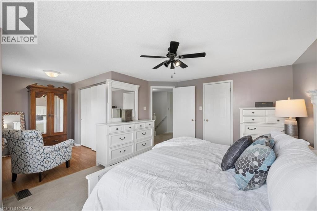 Ceiling fan with integrated lighting, two white panel doors, and neutral wall paint - 67 Apple Tree Drive, Kitchener, ON