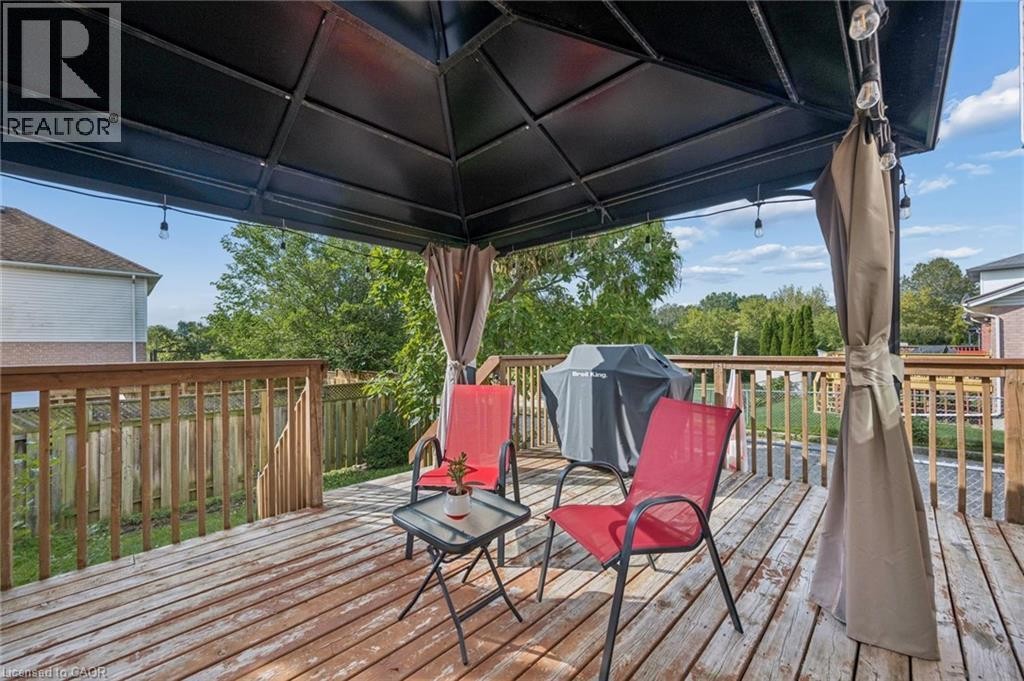 Expansive wood deck with a built-in gazebo featuring a dark canopy - 67 Apple Tree Drive, Kitchener, ON