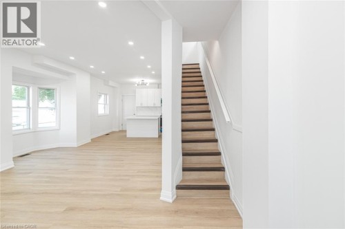 Light wood-finish flooring, recessed lighting, and a bay window - 90 Belview Avenue, Hamilton, ON 