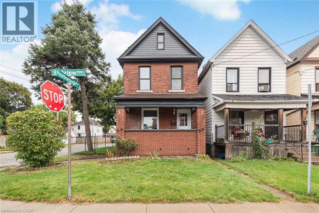 Brick exterior with a covered porch, dark trim accents, and a gabled roofline - 90 Belview Avenue, Hamilton, ON