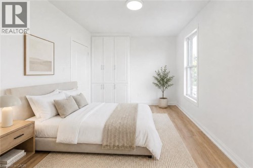 Recessed ceiling light, white painted walls, wood-finish flooring, white window trim, and built-in white cabinetry - 90 Belview Avenue, Hamilton, ON 