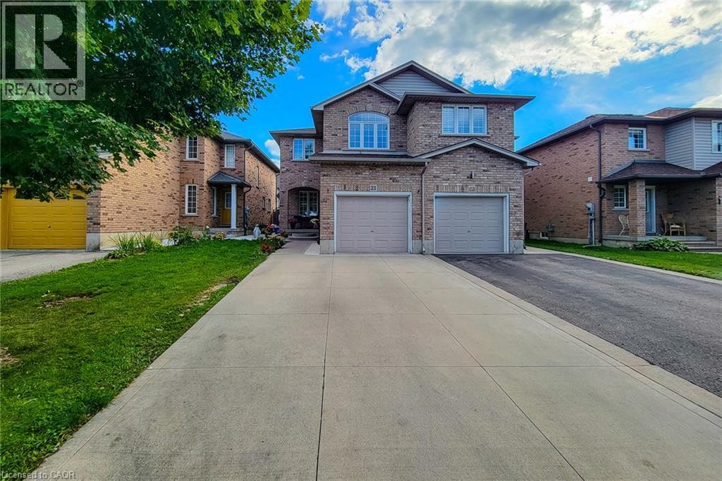 Brick exterior with a gabled roof and arched entry - 21 Jonathon Court, Hamilton, ON