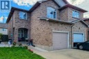 Brick exterior with an arched entryway and covered porch - 21 Jonathon Court, Hamilton, ON 