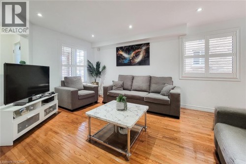 Recessed lighting illuminates the wood-finish flooring and white walls - 21 Jonathon Court, Hamilton, ON 