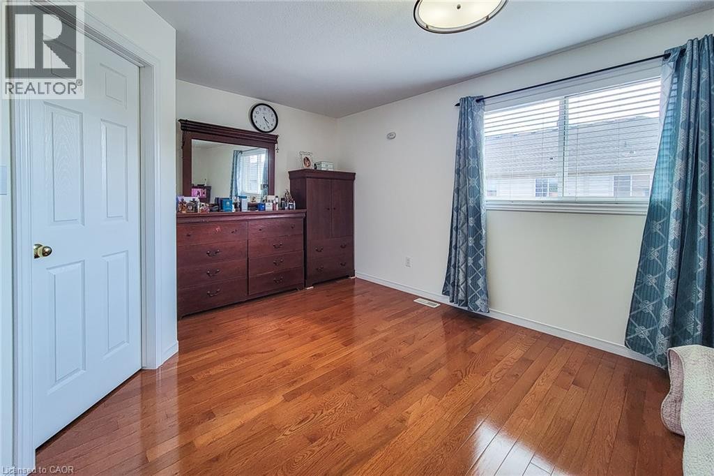 Wood-finish flooring, white walls, and a window with blinds - 21 Jonathon Court, Hamilton, ON