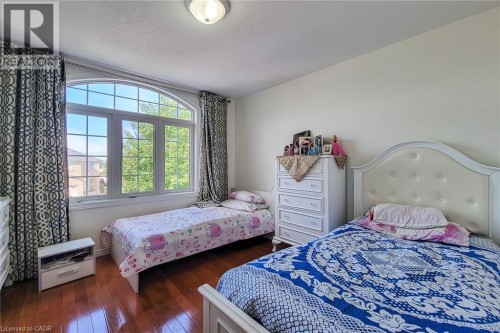 Hardwood flooring, arched window with grid pattern, neutral wall color, recessed ceiling light - 21 Jonathon Court, Hamilton, ON 