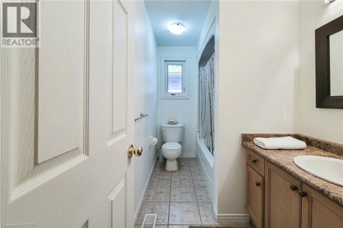 Bathroom with a vanity featuring a built-in sink, a shower-tub combination, and tiled flooring - 21 Jonathon Court, Hamilton, ON 