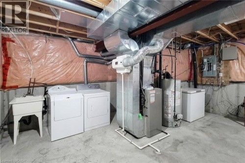 Concrete flooring with a utility sink, exposed ceiling joists, and a forced air system - 21 Jonathon Court, Hamilton, ON 