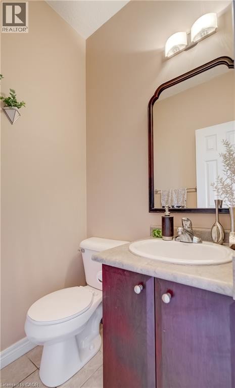 Built-in vanity with a circular basin sink and a wood-finish cabinet - 573 Robert Ferrie Drive, Kitchener, ON