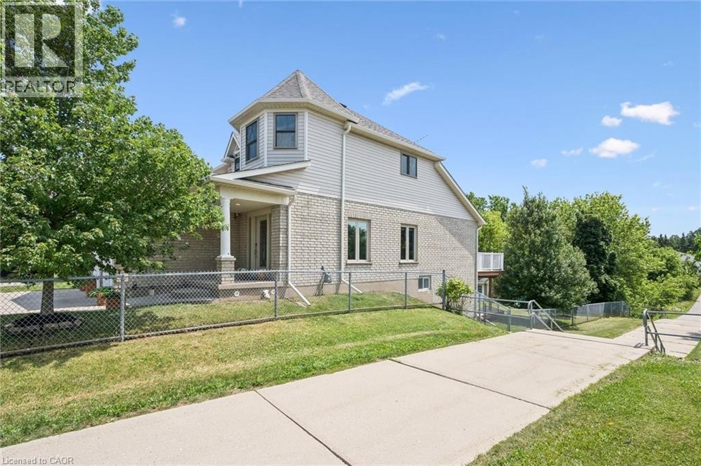 Brick and siding exterior with a covered porch featuring white columns - 426 Hidden Creek Drive, Kitchener, ON