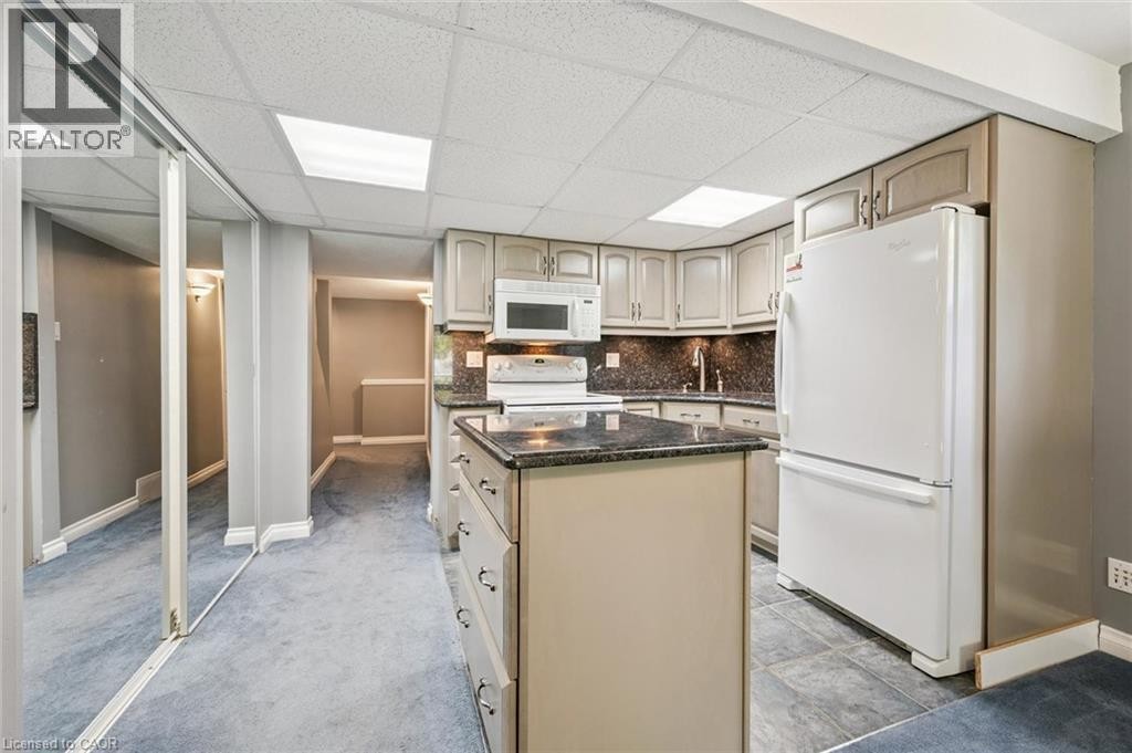 Kitchen featuring a central island, recessed lighting, and ample cabinetry - 426 Hidden Creek Drive, Kitchener, ON
