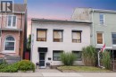 White exterior with dark-trimmed windows and a front entrance - 355 Macnab Street N, Hamilton, ON 