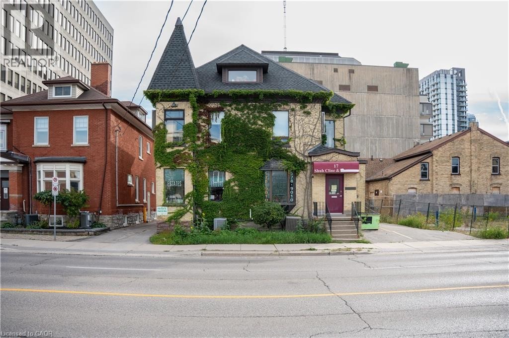 Stone facade with ivy accents, turret feature, dormer window, and a prominent bay window - 17 Weber Street W, Kitchener, ON