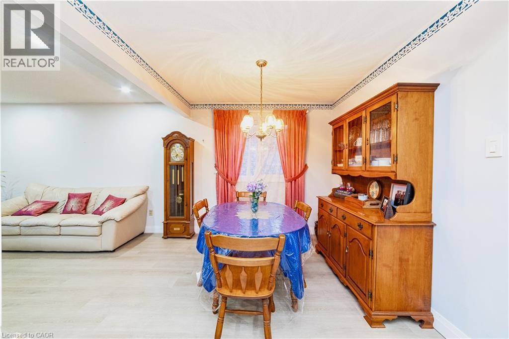 Recessed ceiling lighting, a decorative ceiling trim, light-toned wood-finish flooring, and a window with drapery - 41 Tuerr Drive, Kitchener, ON