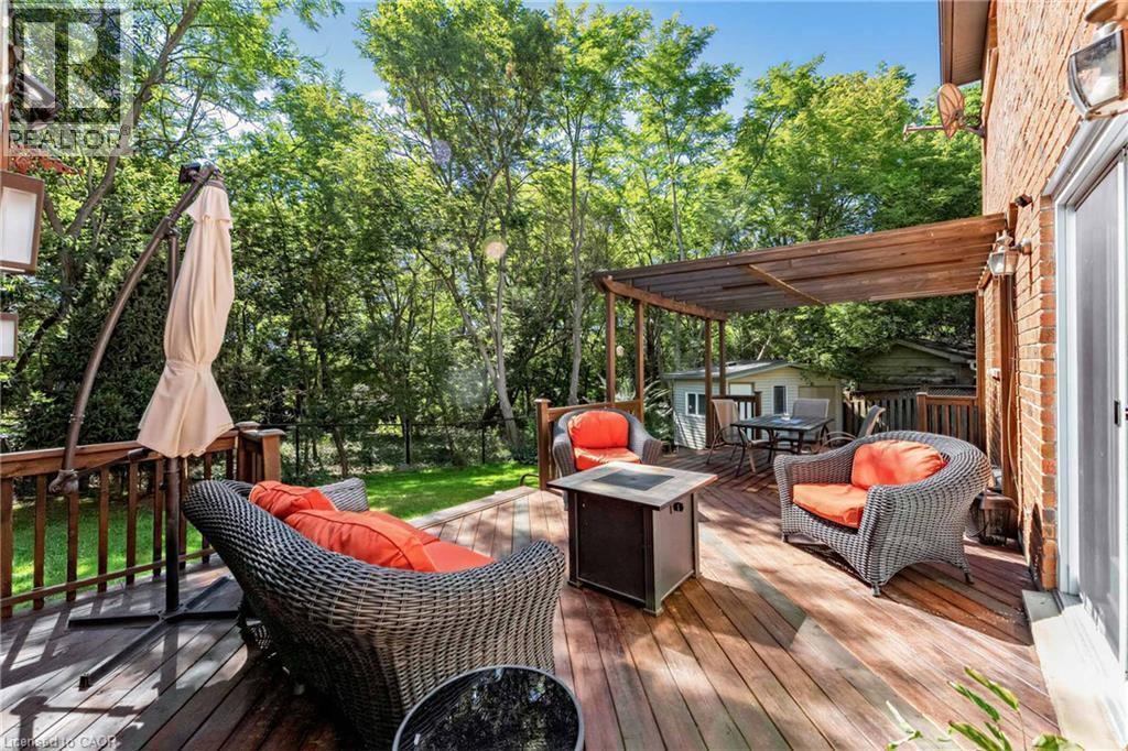 Expansive wood deck with a built-in pergola, offering a private outdoor area - 125 Langlaw Drive, Cambridge, ON