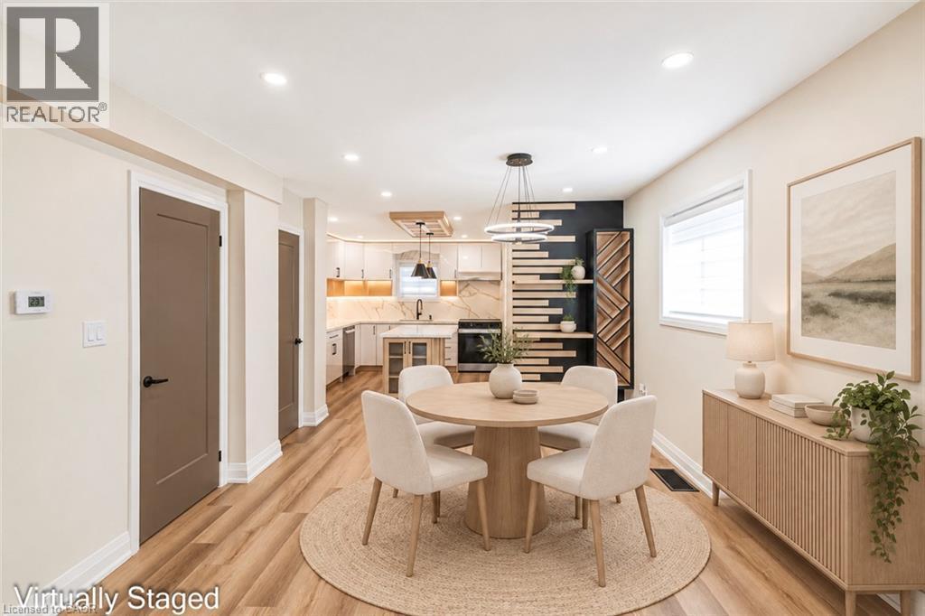 Wood-finish flooring throughout, recessed ceiling lighting, and a kitchen with white cabinetry - 250 Rosslyn Avenue N, Hamilton, ON