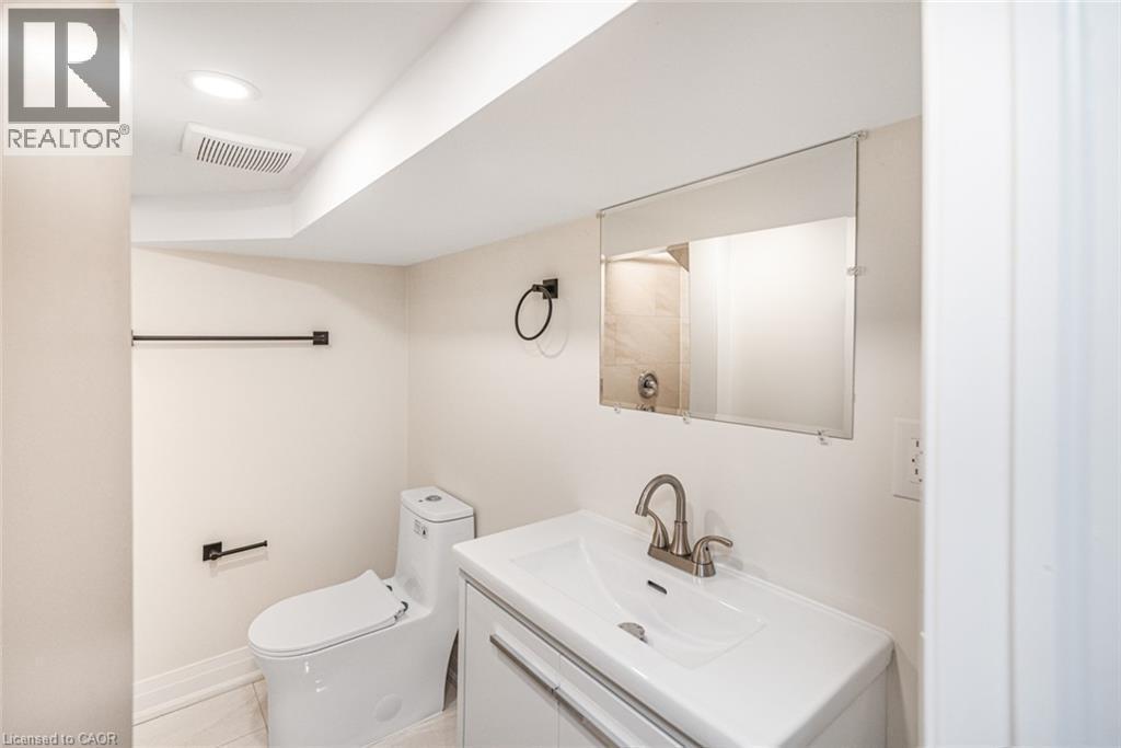 Modern vanity with an integrated sink and brushed nickel faucet - 250 Rosslyn Avenue N, Hamilton, ON