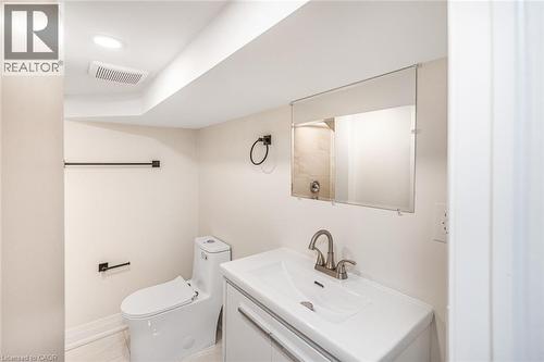 Modern vanity with an integrated sink and brushed nickel faucet - 250 Rosslyn Avenue N, Hamilton, ON 