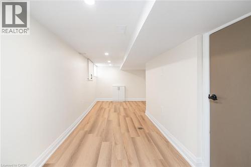 Recessed ceiling lighting, wood-finish flooring, white walls, and built-in white cabinetry - 250 Rosslyn Avenue N, Hamilton, ON 