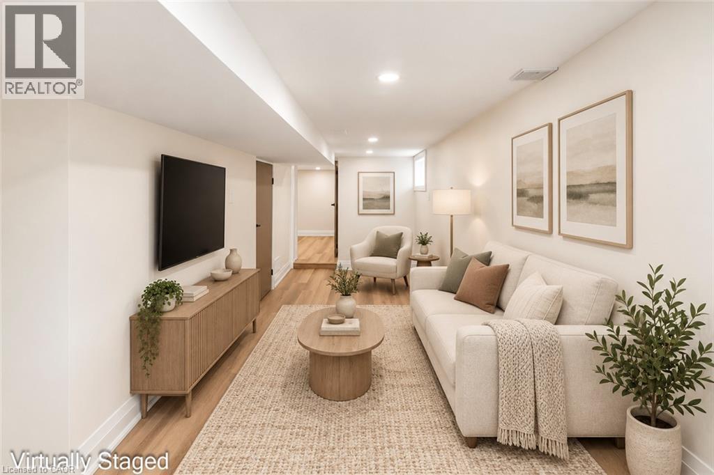 Recessed lighting illuminates wood-finish flooring throughout the space - 250 Rosslyn Avenue N, Hamilton, ON
