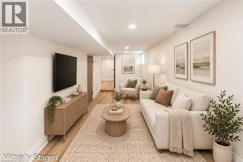 Recessed lighting illuminates wood-finish flooring throughout the space - 250 Rosslyn Avenue N, Hamilton, ON 