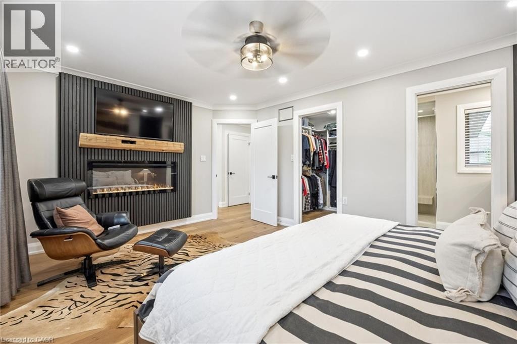 Recessed lighting, wood-finish flooring, built-in fireplace, ceiling fan with light fixture, and a built-in closet system - 1261 Stephenson Drive, Burlington, ON