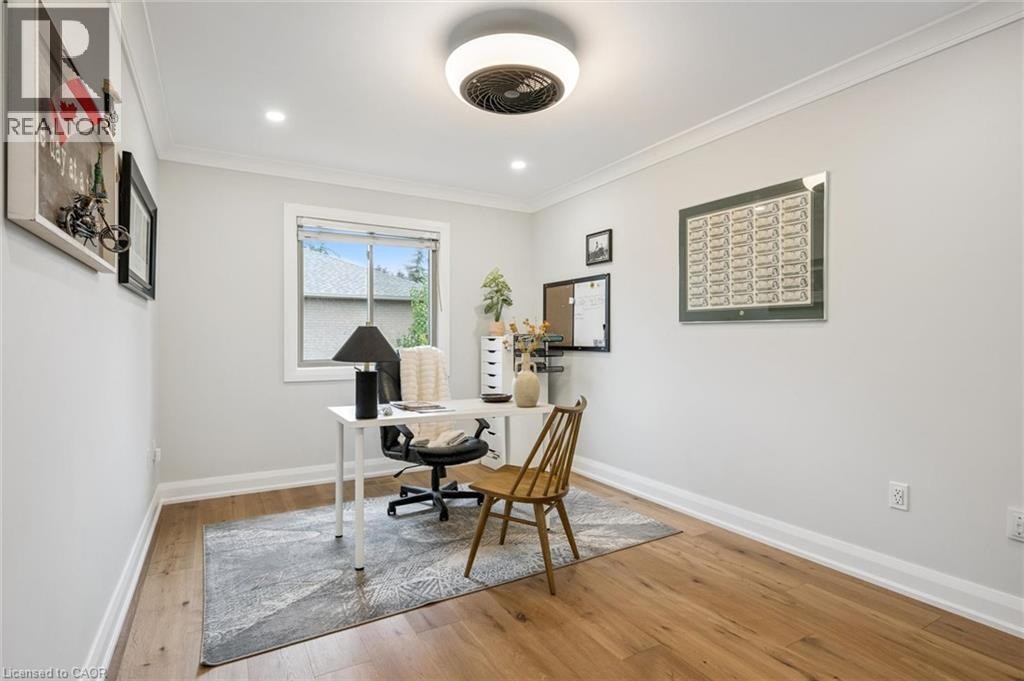 Hardwood-style flooring, crown molding, recessed lighting, and a modern ceiling fixture - 1261 Stephenson Drive, Burlington, ON