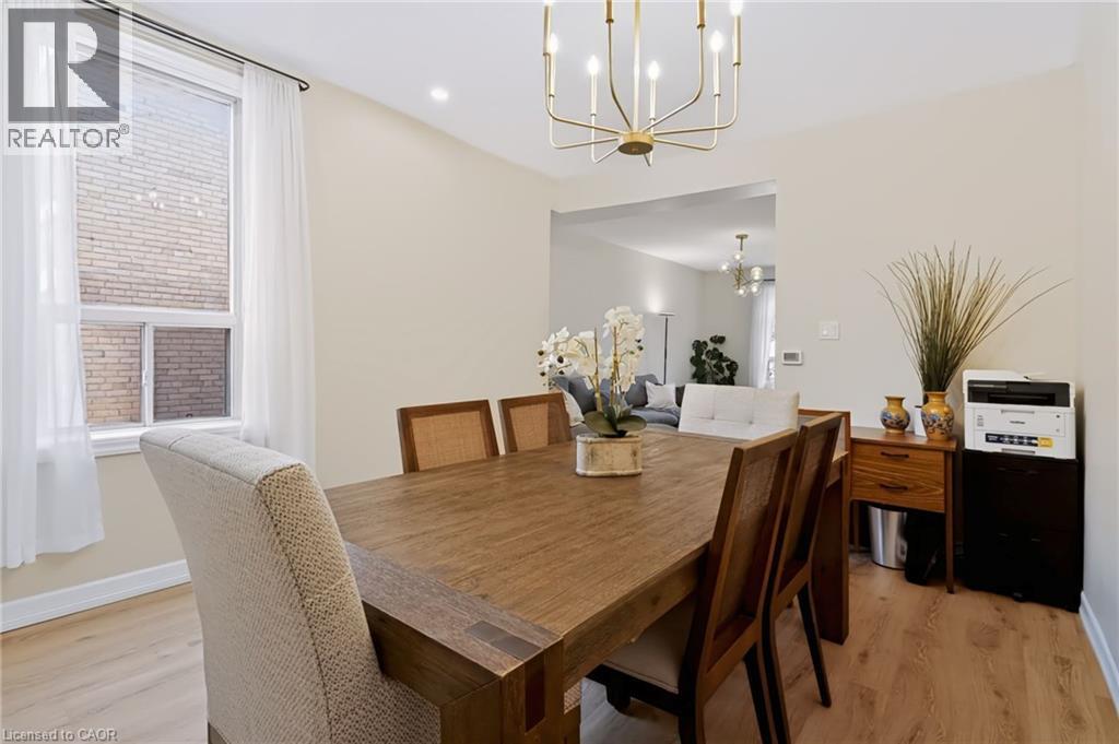 Recessed lighting, wood-finish flooring, and a contemporary chandelier - 34 Baillie Street, Hamilton, ON