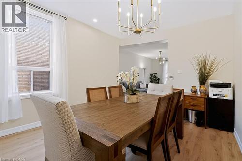 Recessed lighting, wood-finish flooring, and a contemporary chandelier - 34 Baillie Street, Hamilton, ON 