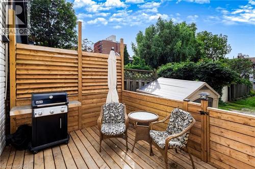 Wood deck with slatted wood privacy fencing and integrated gate - 34 Baillie Street, Hamilton, ON 