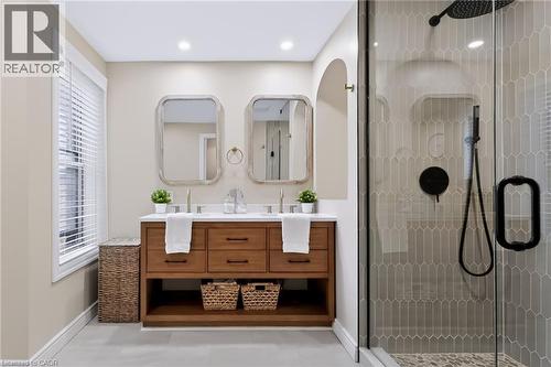 Dual vanity with wood-finish cabinetry and white countertops - 34 Baillie Street, Hamilton, ON 