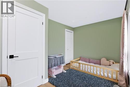 Wood-finish flooring with light green wall paint - 34 Baillie Street, Hamilton, ON 